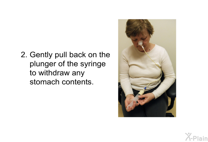 Gently pull back on the plunger of the syringe to withdraw any stomach contents.