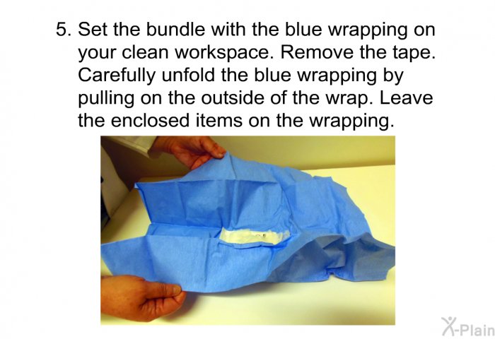 Set the bundle with the blue wrapping on your clean workspace. Remove the tape. Carefully unfold the blue wrapping by pulling on the outside of the wrap. Leave the enclosed items on the wrapping.